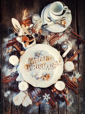 Merry Christmas Decor on Wooden Table. Baked Letters. Top view