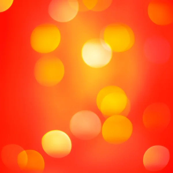 Яскраві розфокусовані червоні помаранчеві кольорові вогні. Святковий фон — стокове фото