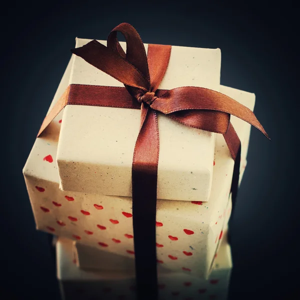 Gifts in Vintage Handmade Paper with Brown Bow — Stock Photo, Image
