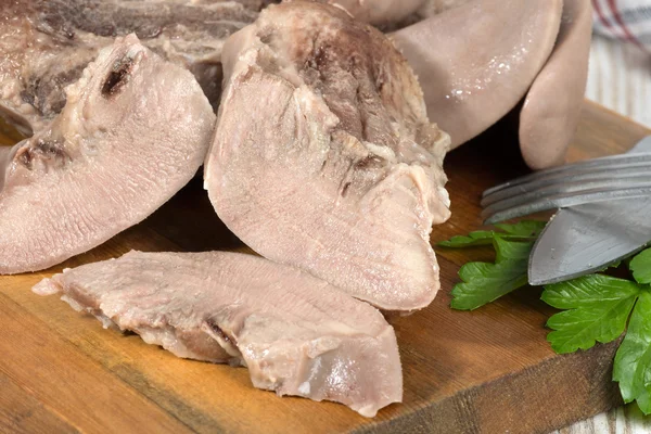 Boiled pork tongues are on cutting board — Stock Photo, Image
