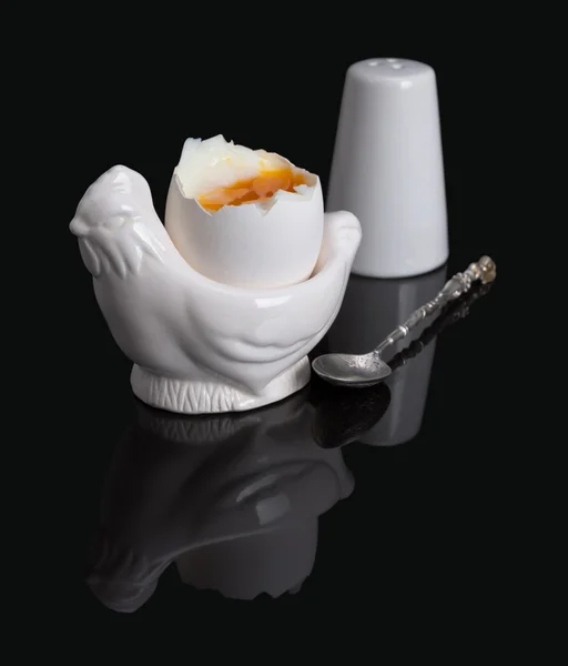 Cooked soft boiled egg, salt shaker and spoon — Stock Photo, Image