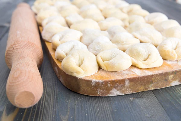 Handmade meat dumplings on the kitchen board — Stock Photo, Image