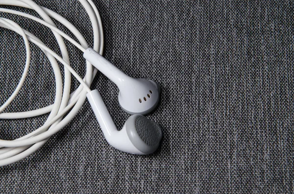 Top view of White Earphones on silver background. Copy space. Music is my life concept