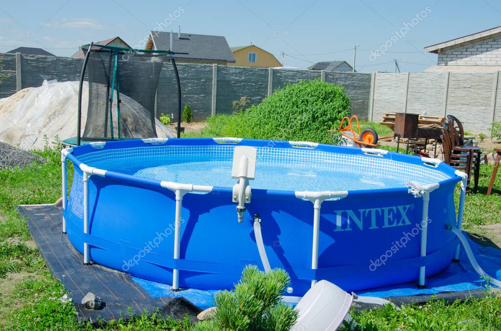 Mobile pool in the backyard, INTEX brand , round outdoor pool for the whole family on the lawn in summer, July 15, 2021, Gomel, Belarus