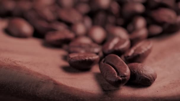 Fragrant roasted coffee beans on wooden background — Stock Video