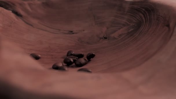 Falling Fragrant roasted coffee beans on plate — Stock Video