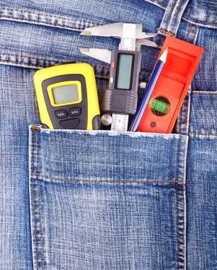 Construction tools in jeans pocket clipart