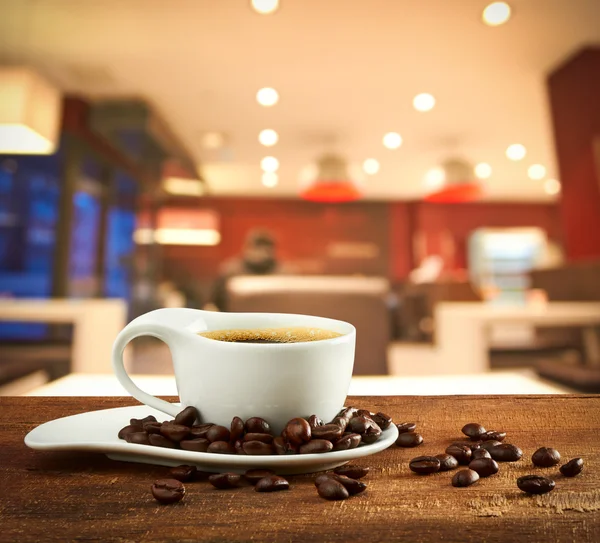 Cup of coffee on blur cafe background — Stock Photo, Image