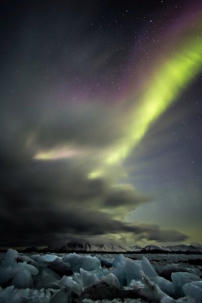 Natural phenomenon of Northern Lights (Aurora Borealis) - vertical photo