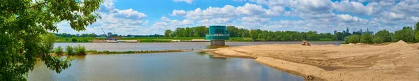 Gruba Kaska - water filtration station on the Vistula river in Warsaw. Panorama overlooking the river and sand on the shore