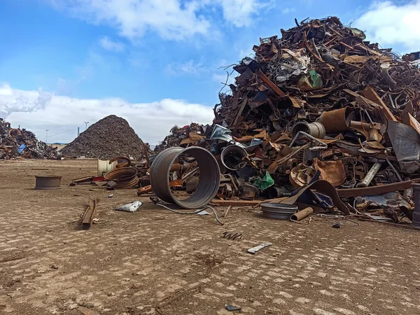 old rims and scrap metal at the port for shipment to the ship for processing. Recycling of recyclable materials. Scrap metal prepared for shipment by sea transport for processing.