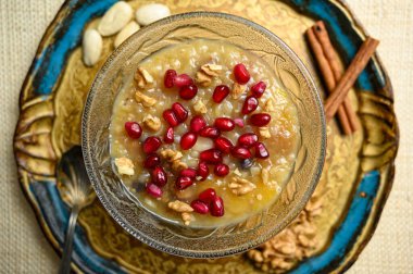 Kül ya da Nuh 'un pudingi, altın tepside cam kasede Türk tatlısı lapası.