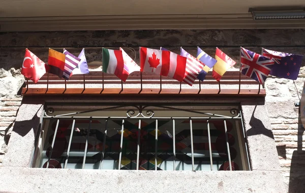 Little country flags on a hotel window — Stock Photo, Image