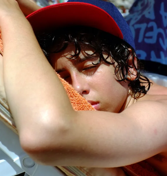 Jeune adolescent garçon dormir sur la plage — Photo