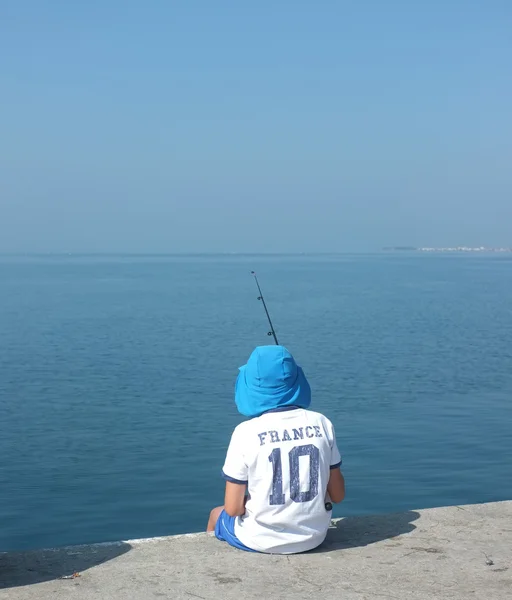 Young boy fishing with rod — Stock Photo, Image