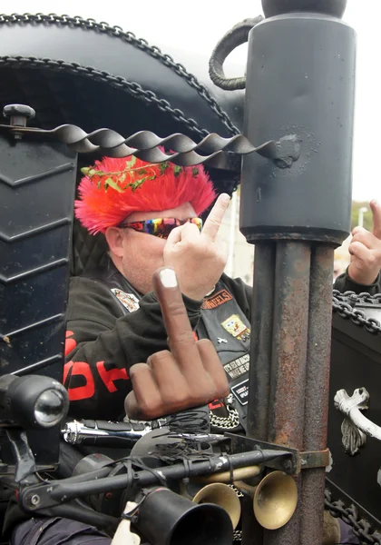 Bikers makes a naughty gesture on his bike — Stock Photo, Image