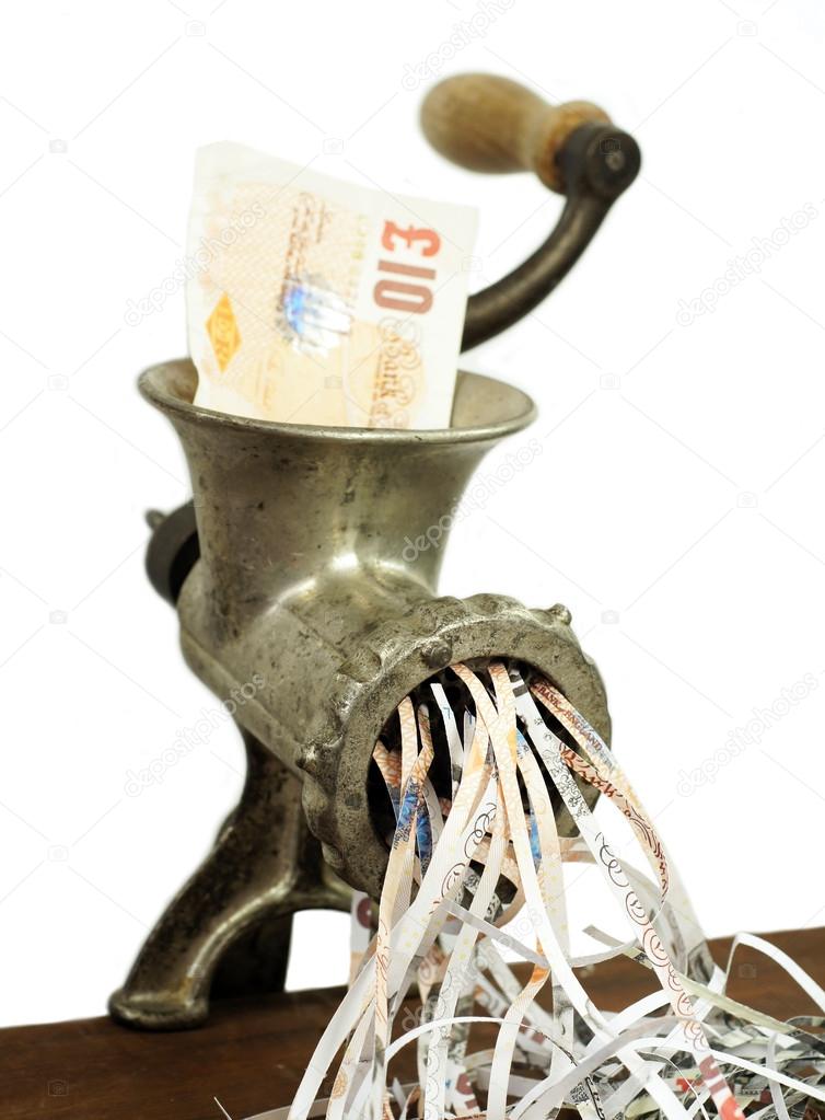 Pound note in a meat grinder