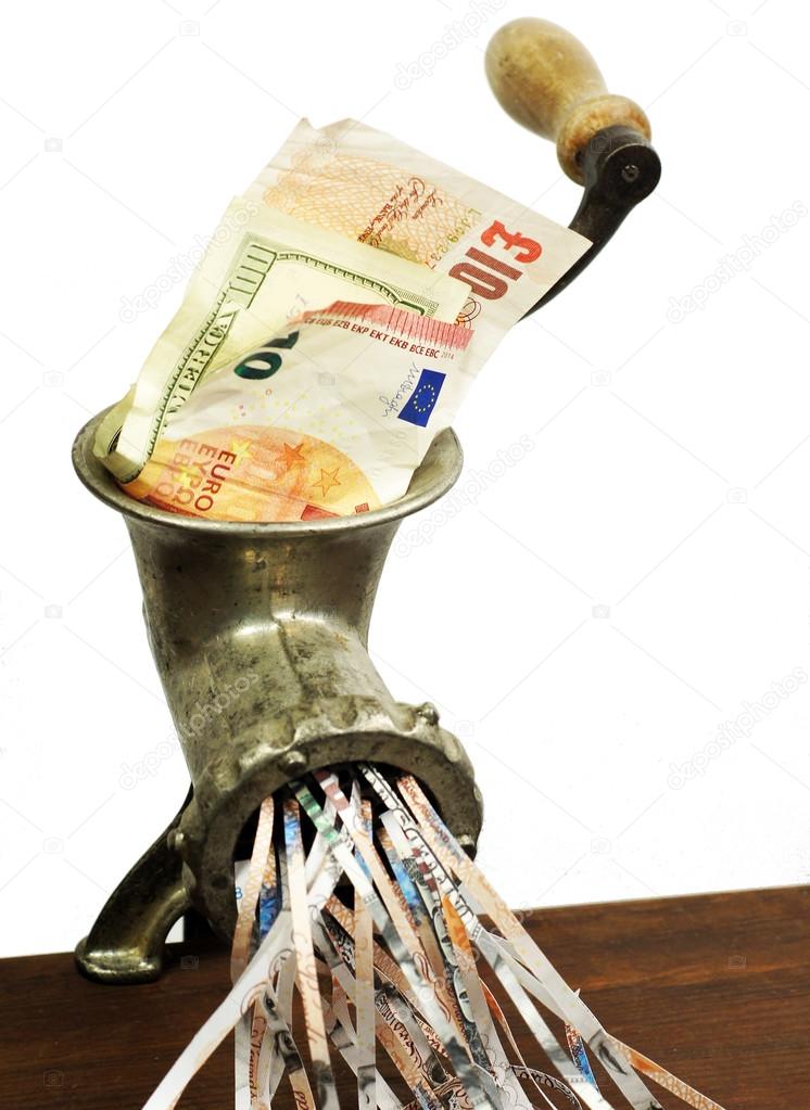 Different currency notes in a meat grinder