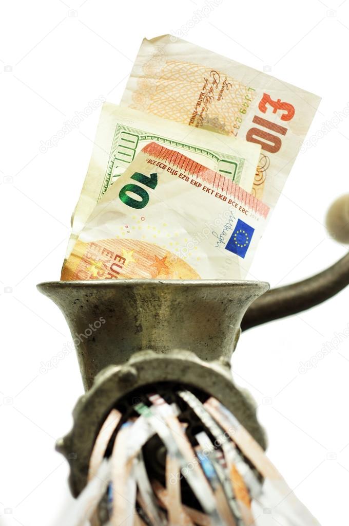 Different currency notes in a meat grinder