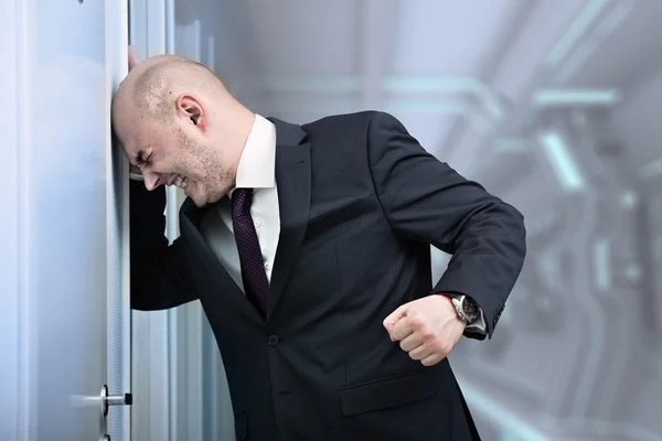 Businessman in fury banging head — Stock Photo, Image