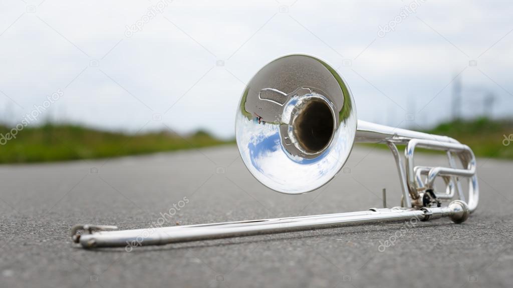 Fragment outdoor lying trombone closeup