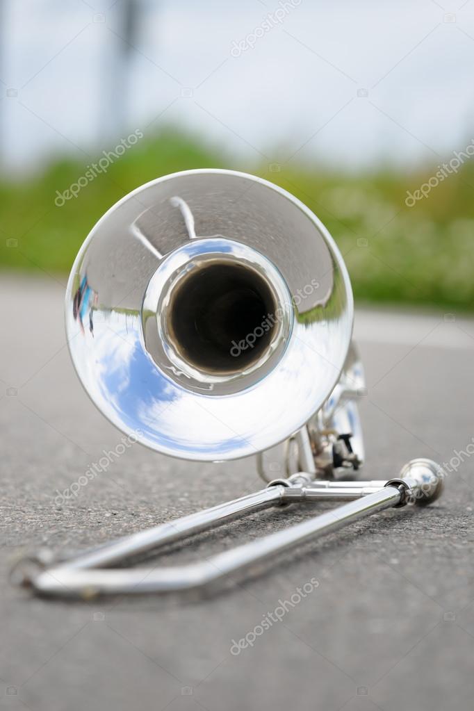 Fragment outdoor lying trombone closeup