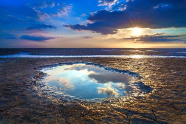 Wadden Sea in the Netherlands during sunset with wid angel view and colorful clouds. clipart