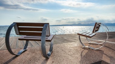 chairs overlooking the lake garda clipart
