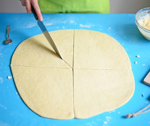 Cutting raw dough in flour with a knife — Stock Photo, Image
