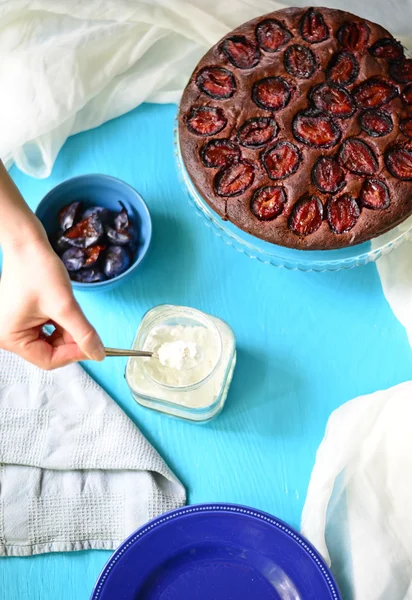 Plum cake on blue background — Stock Photo, Image