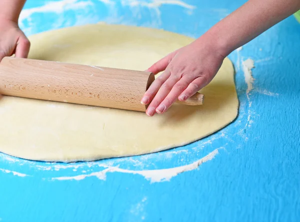 Hands baking dough with rolling pin on table — Stock Photo, Image