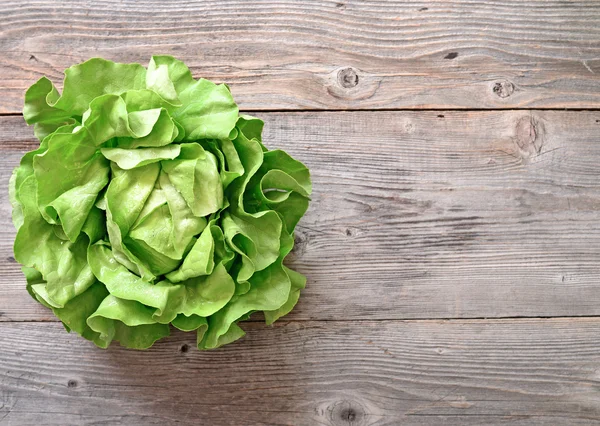 Green salad on wooden background — Stock Photo, Image