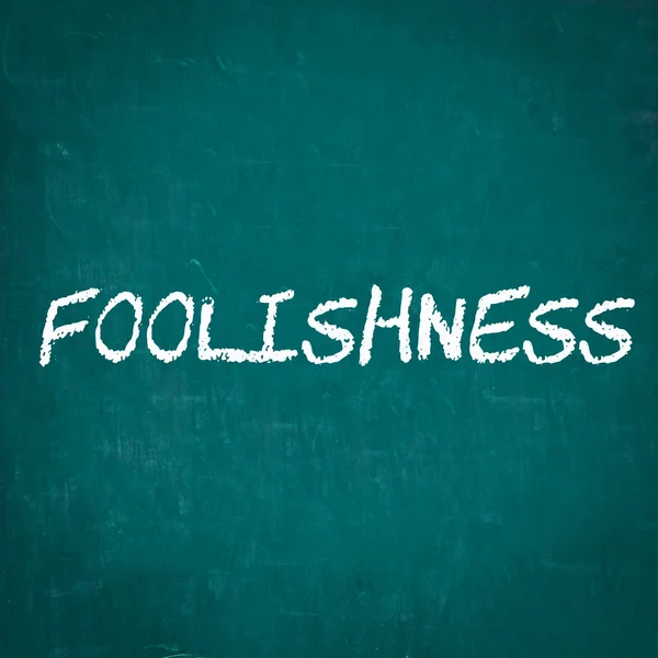 FOOLISHNESS written on chalkboard — Stock Photo, Image