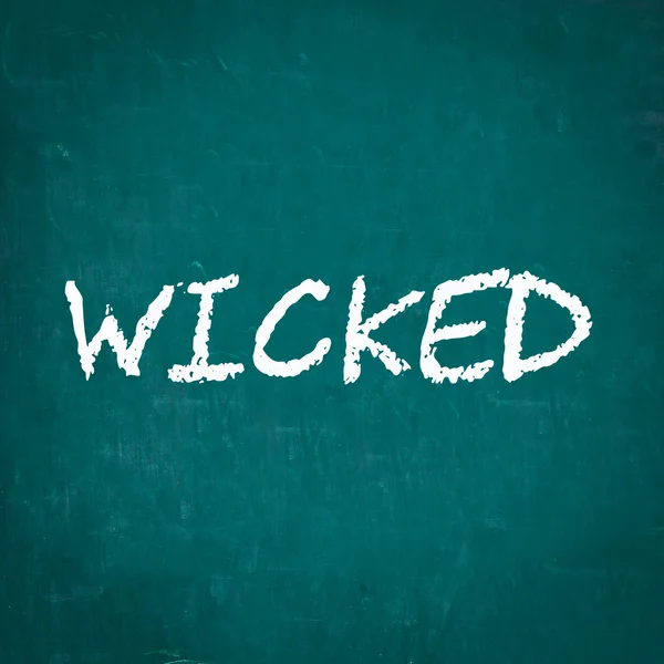 WICKED written on chalkboard — Stock Photo, Image