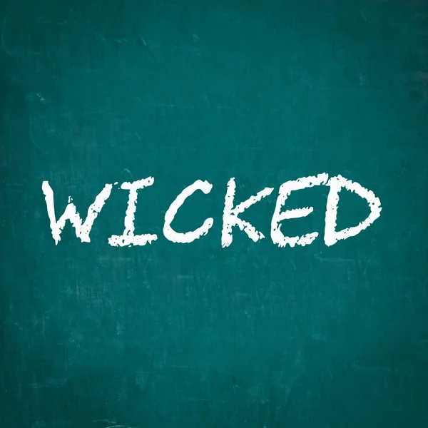 WICKED escrito em quadro-negro — Fotografia de Stock