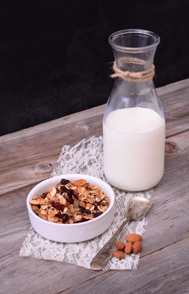 Granola Cereal with bottle of milk on wooden table — Stock Photo, Image