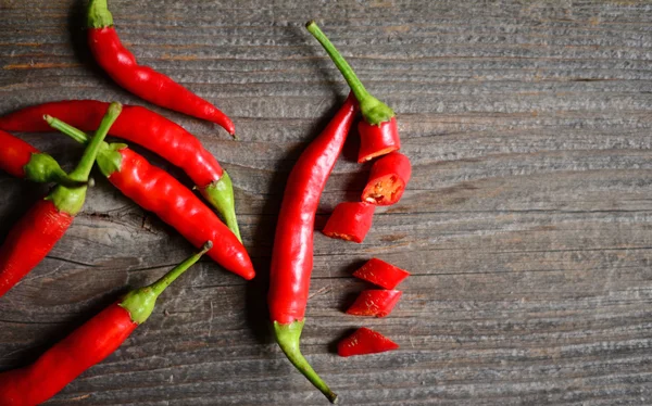 Chilly pepper on the old wooden table Stock Photo