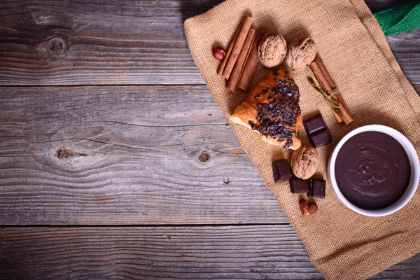 Chocolate croissant on wooden background — Stock Photo, Image