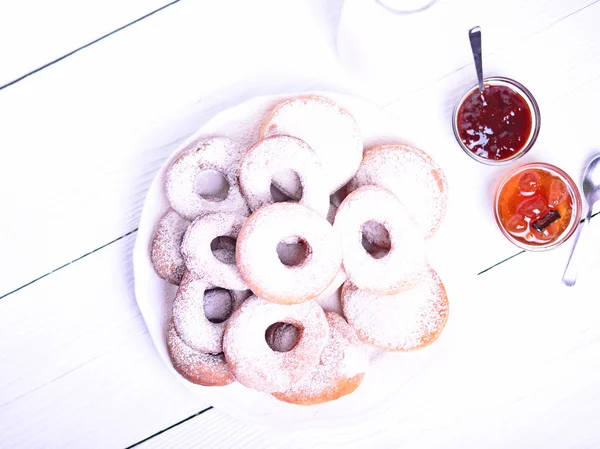 Fresh donuts on white wooden table — Stock Photo, Image