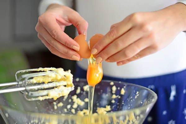 Closeup of a pair of hands cracking an egg into a glass bowl — Stock Photo, Image