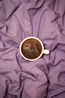 Yatak örtüsünün arkasında kahve fincanı var. Aşk ve Sevgililer Günü kavramı 