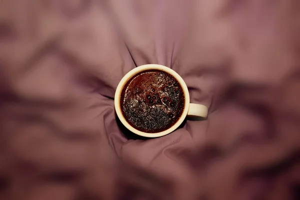 Coffee mug on the background of the bed cloth. The concept of love and valentine's day
