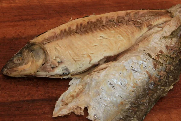 Whole on salt cooked fish with skin removed on one side .Whole fish cooked in a salt