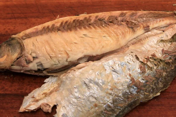 Whole on salt cooked fish with skin removed on one side .Whole fish cooked in a salt