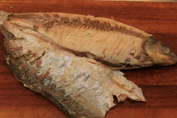 Whole on salt cooked fish with skin removed on one side .Whole fish cooked in a salt