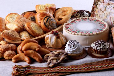 İçinde bir sürü kek, kek ve turta olan bir masa. Beyaz kumaşlarda pasta seçimi. Boşluğu kopyala 