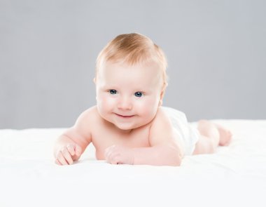 Şirin bir gülümseyen bebek bebek beze sürünerek portresi