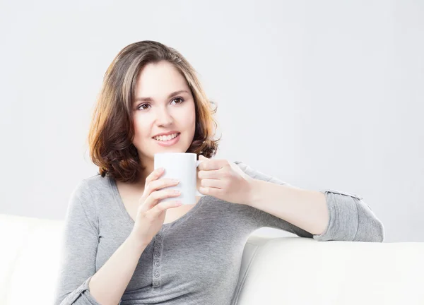 Attractive girl enjoying a cup of coffee at home — Stock Photo, Image