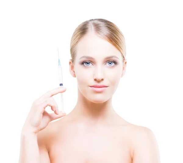 Young woman holding a syringe in her hands and injecting botox ロイヤリティフリーのストック画像