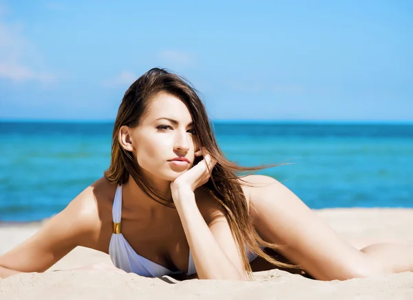 Beautiful young woman relaxing on a summer beach Stock Picture